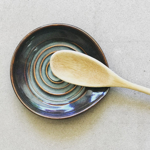 Glaze On Studio - Handmade Pottery for Home and Table - Style meets function and keeps your counters clean with this swirly spoon rest. Iron lustre glaze shows a complex mix of metallic and earth-tones finishes.  Diameter: 5"  Food, dishwasher and microwave safe.  