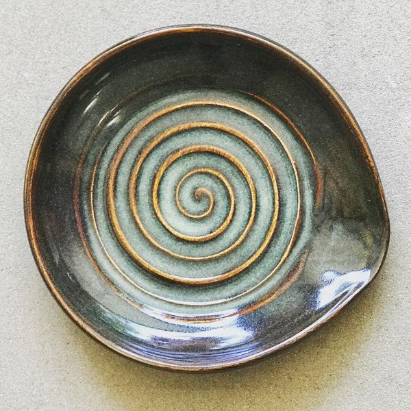 Glaze On Studio - Handmade Pottery for Home and Table - Style meets function and keeps your counters clean with this swirly spoon rest. Iron lustre glaze shows a complex mix of metallic and earth-toned finishes.  Diameter: 5"  Food, dishwasher and microwave safe.  